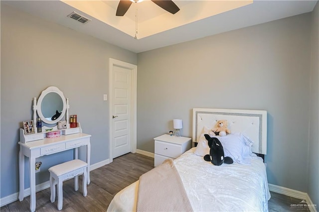 bedroom featuring dark hardwood / wood-style floors and ceiling fan