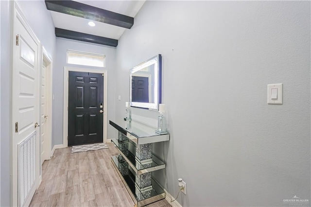 entryway featuring beam ceiling and light hardwood / wood-style flooring