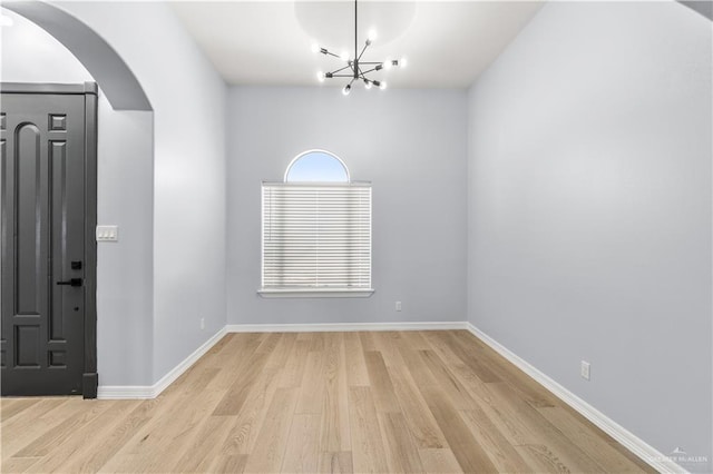 entryway featuring a chandelier and light hardwood / wood-style flooring