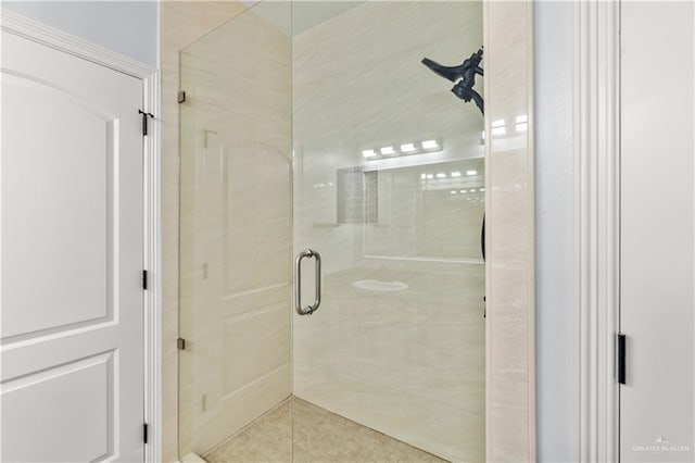 bathroom featuring a shower with shower door