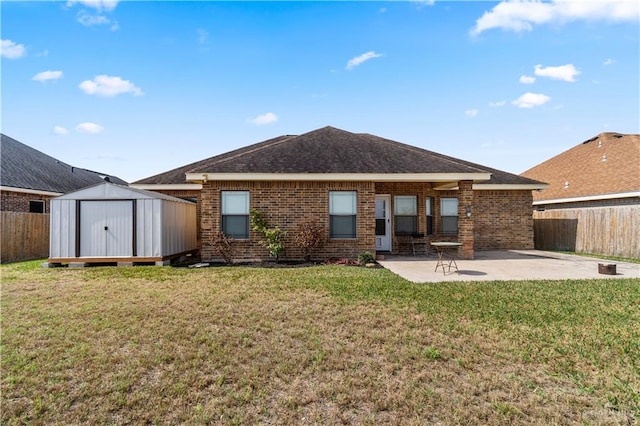 back of house with a yard, a patio area, and a storage unit