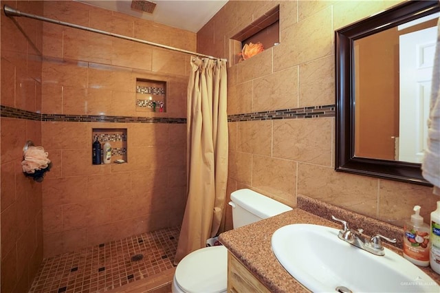 bathroom featuring a shower with shower curtain, vanity, toilet, and tile walls