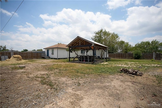 rear view of property featuring a gazebo