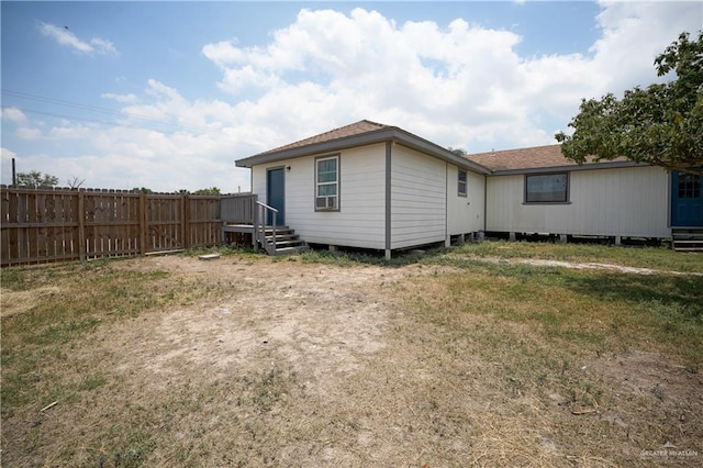 back of property featuring a lawn