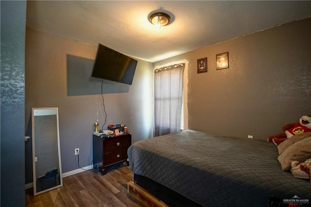 bedroom featuring dark wood-type flooring