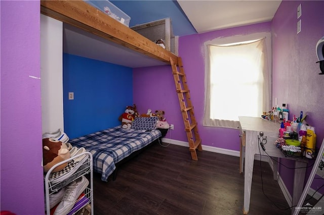 bedroom with dark hardwood / wood-style floors