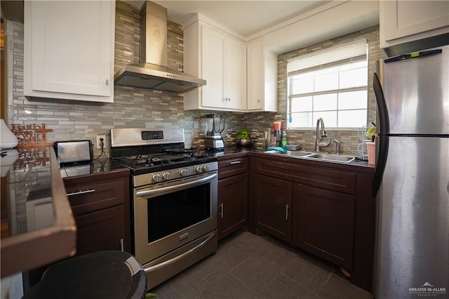 kitchen with white cabinetry, sink, wall chimney range hood, and stainless steel appliances