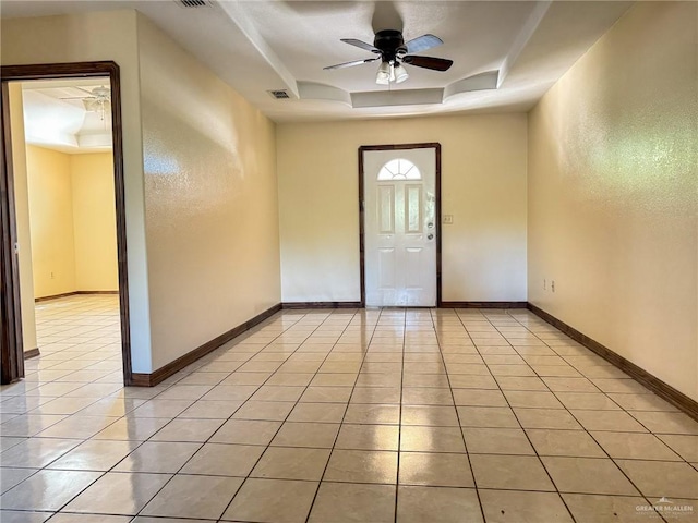 interior space with a tray ceiling and ceiling fan