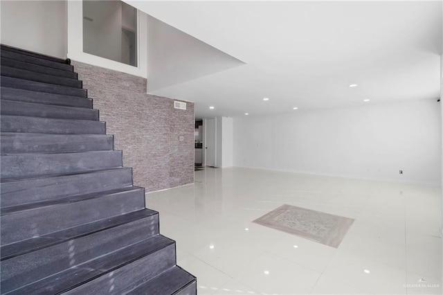 stairway with tile patterned floors