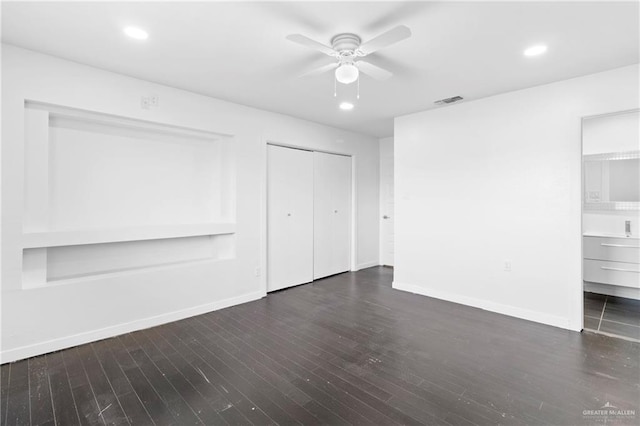 unfurnished bedroom featuring dark hardwood / wood-style floors, ceiling fan, and ensuite bath