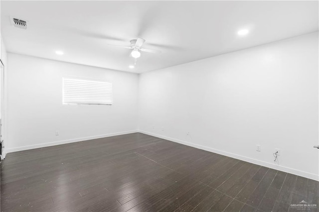 spare room featuring dark hardwood / wood-style floors and ceiling fan