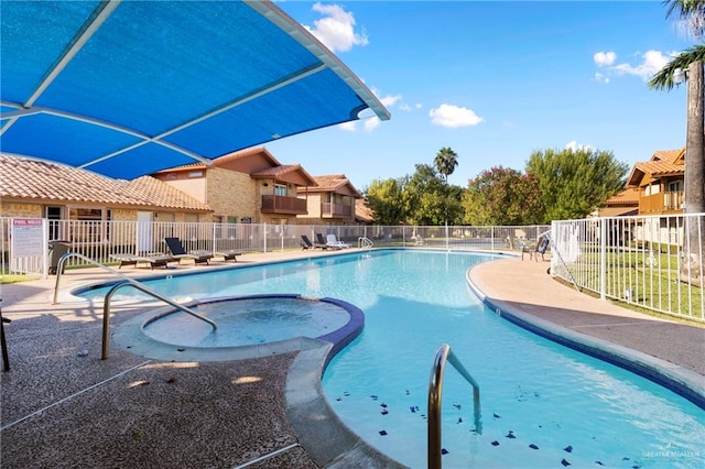 view of swimming pool with a patio and a hot tub