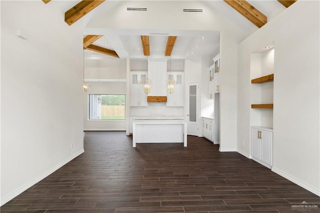 unfurnished living room with beamed ceiling, dark hardwood / wood-style floors, and high vaulted ceiling