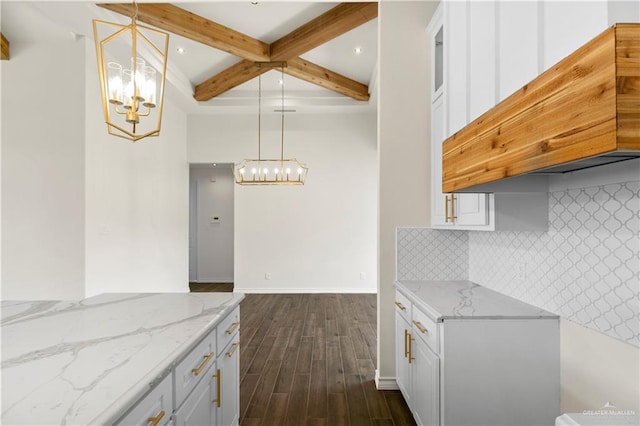 kitchen featuring beam ceiling, white cabinetry, hanging light fixtures, and dark hardwood / wood-style floors