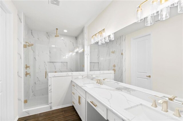 bathroom featuring vanity, an enclosed shower, and wood-type flooring