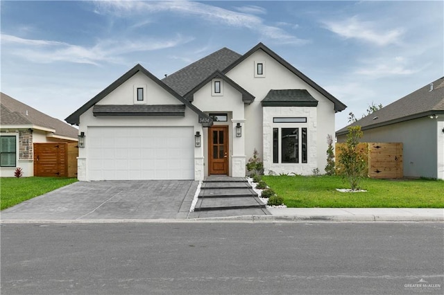 view of front of property featuring a garage and a front lawn