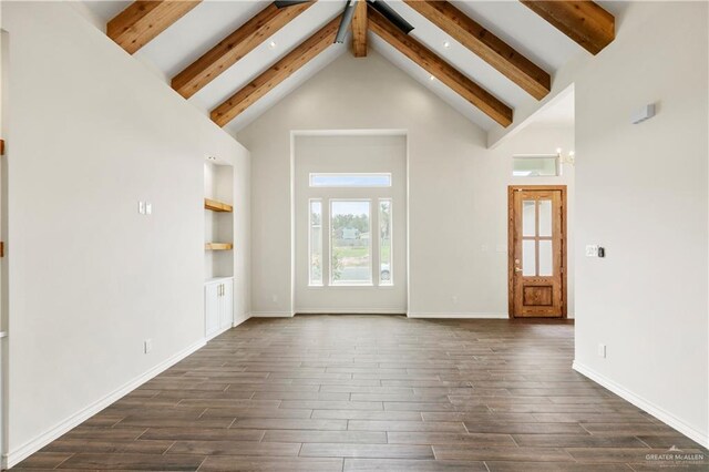 interior space with beam ceiling, dark hardwood / wood-style floors, high vaulted ceiling, and built in shelves