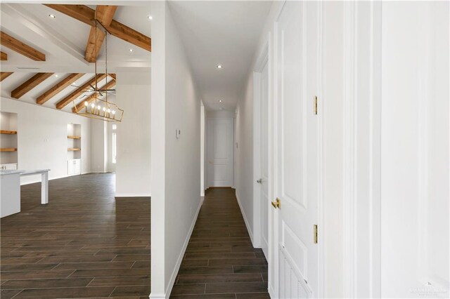 corridor featuring beamed ceiling and dark wood-type flooring