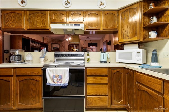 kitchen featuring under cabinet range hood, light countertops, electric range, and white microwave