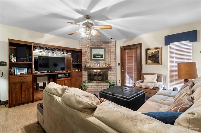 living area with ceiling fan, a fireplace, a wealth of natural light, and light colored carpet