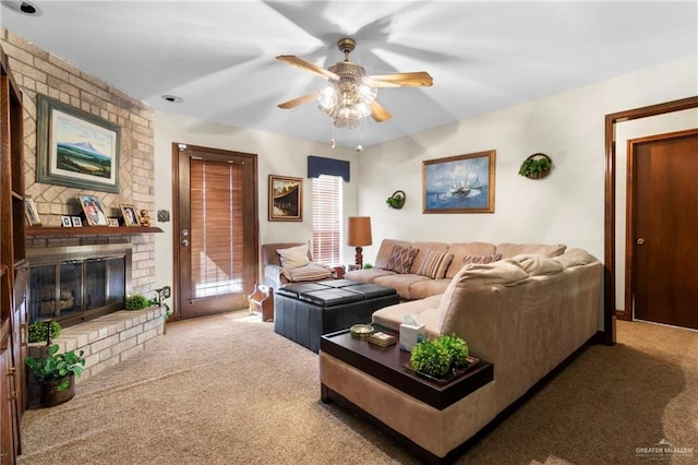 living area featuring carpet, ceiling fan, and a brick fireplace