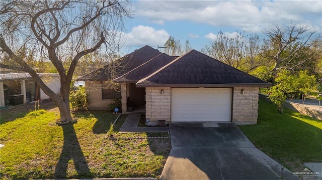 ranch-style home featuring a garage, brick siding, concrete driveway, roof with shingles, and a front yard