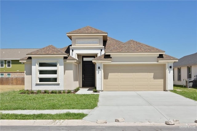 view of front of house with a garage and a front lawn