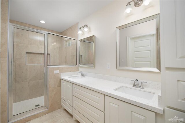 bathroom with vanity, tile patterned floors, and a shower with shower door