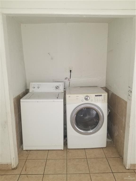 515 Holland Ave, Mission, TX 78572 - washroom with washer and dryer and light tile patterned floors
