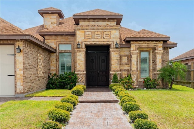 entrance to property with a lawn