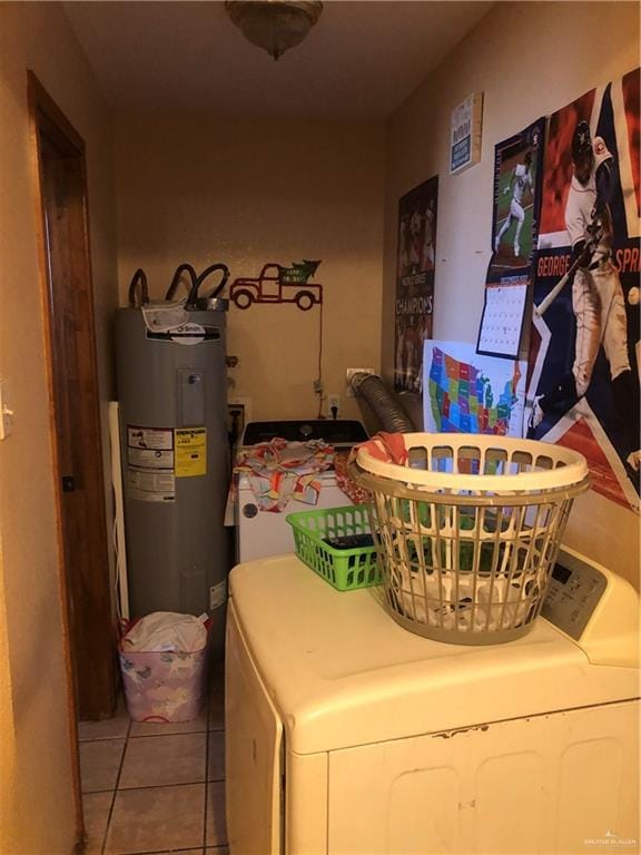 clothes washing area with electric water heater, light tile patterned floors, and separate washer and dryer