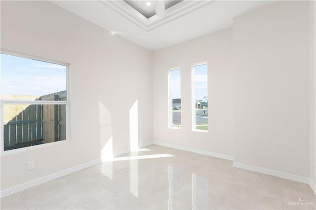 unfurnished room with baseboards and a healthy amount of sunlight