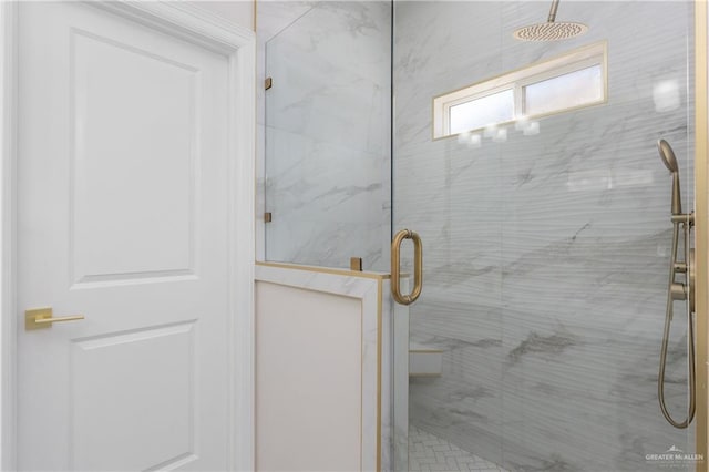 full bathroom featuring a marble finish shower