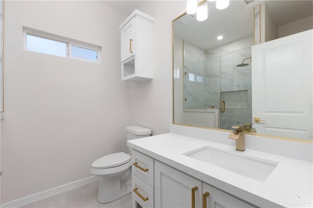 full bath featuring toilet, a shower stall, baseboards, and vanity