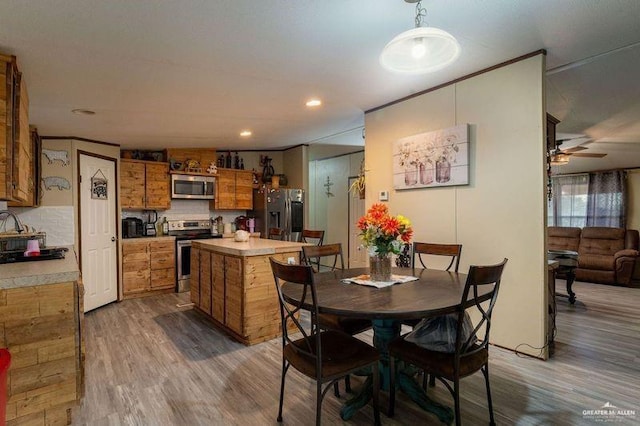 dining room featuring ornamental molding, recessed lighting, ceiling fan, and wood finished floors