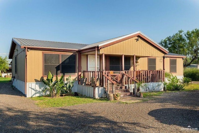 manufactured / mobile home featuring metal roof and a porch