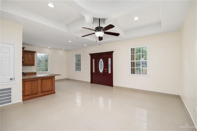 tiled foyer featuring beam ceiling, ceiling fan, and coffered ceiling