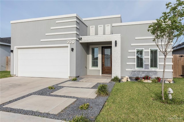 220 Stella Dr, San Juan, TX 78589 - contemporary house with stucco siding, driveway, and a front yard