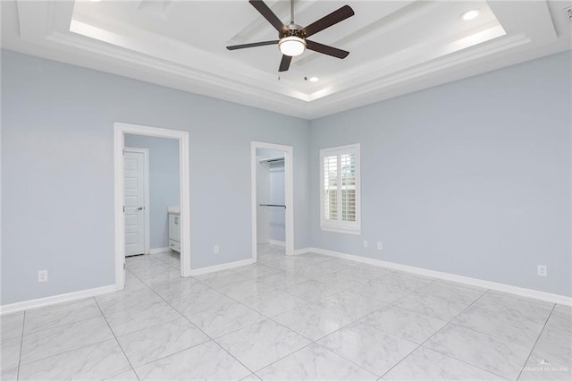 220 Stella Dr, San Juan, TX 78589 - unfurnished bedroom with baseboards, a spacious closet, recessed lighting, connected bathroom, and a raised ceiling
