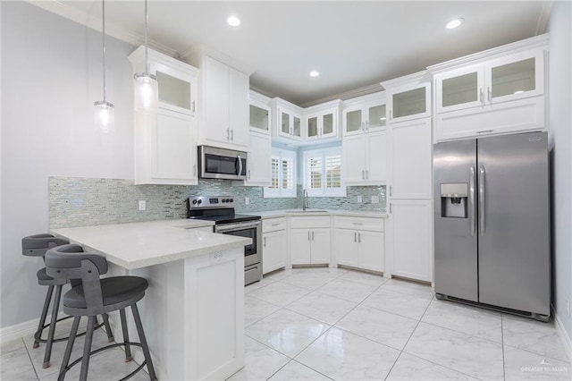 220 Stella Dr, San Juan, TX 78589 - kitchen featuring a sink, stainless steel appliances, light countertops, white cabinets, and a peninsula