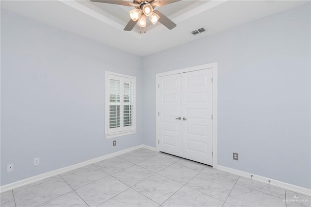 220 Stella Dr, San Juan, TX 78589 - unfurnished bedroom featuring a closet, marble finish floor, ceiling fan, baseboards, and visible vents