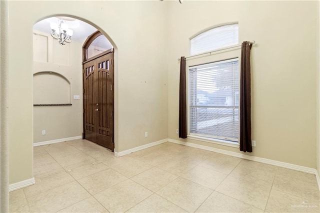 entrance foyer featuring a notable chandelier and light tile patterned floors