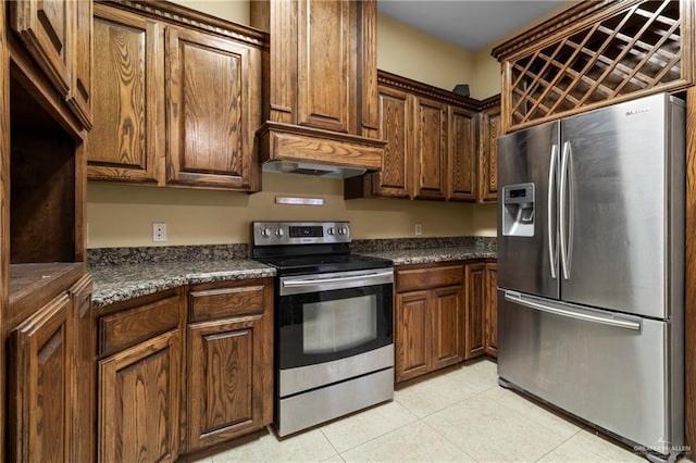 kitchen with premium range hood, appliances with stainless steel finishes, and light tile patterned floors