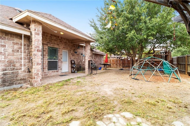 view of yard with a playground and a patio area