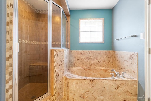 bathroom featuring shower with separate bathtub