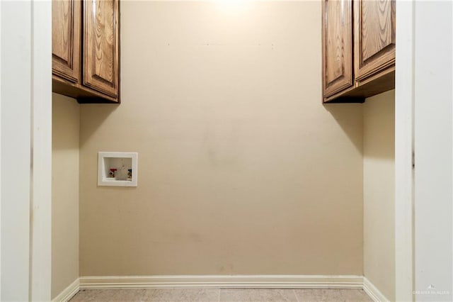 clothes washing area featuring cabinets and washer hookup