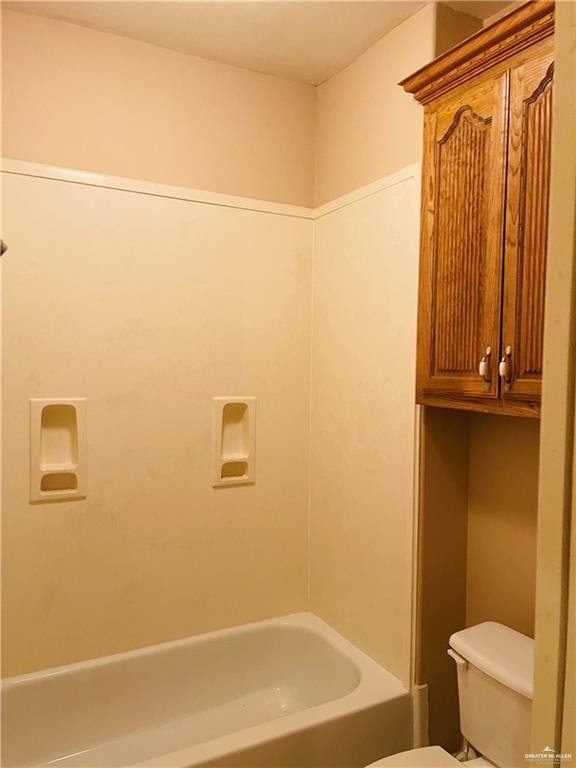 full bathroom featuring toilet and tub / shower combination