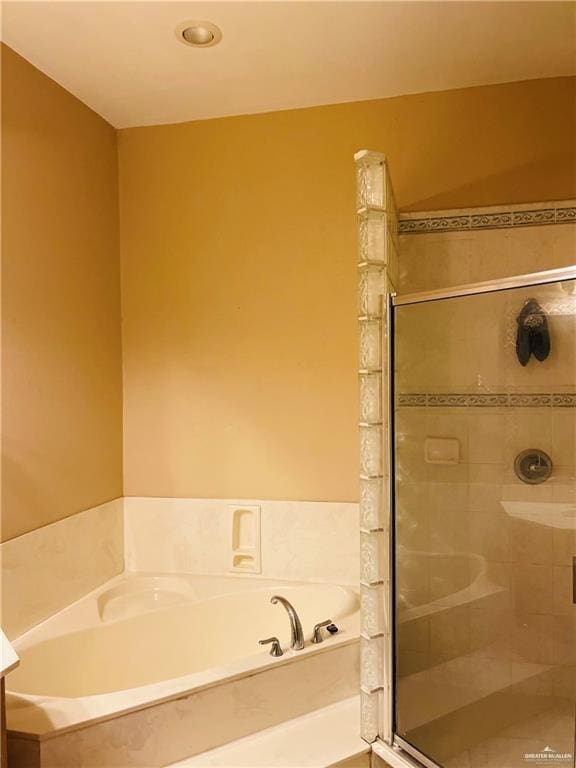 bathroom featuring a stall shower, a garden tub, and recessed lighting