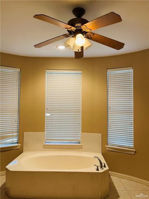 full bath featuring tile patterned flooring, a garden tub, baseboards, a ceiling fan, and recessed lighting
