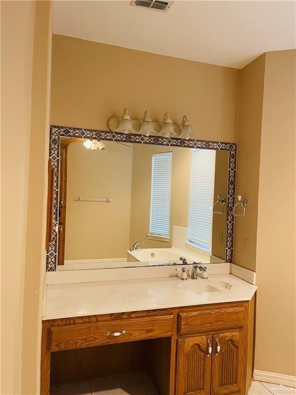 bathroom featuring tile patterned flooring and vanity